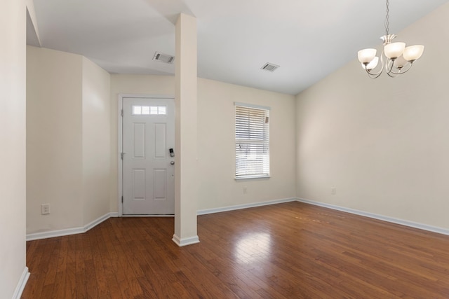 entryway featuring dark hardwood / wood-style flooring and a notable chandelier