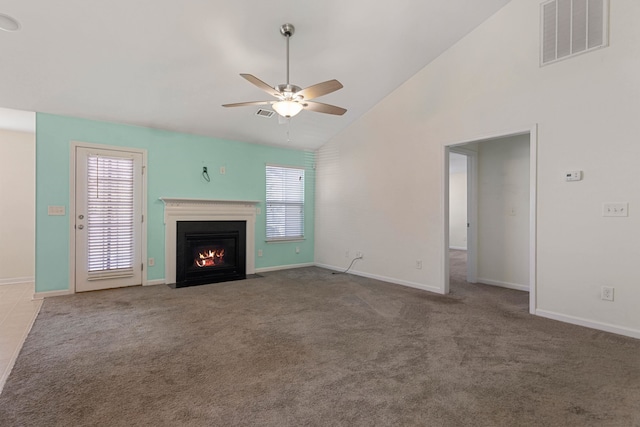 unfurnished living room with carpet, ceiling fan, and high vaulted ceiling