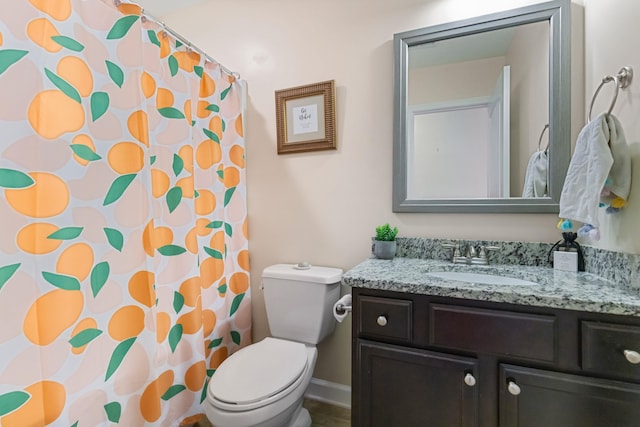 bathroom with vanity, curtained shower, and toilet