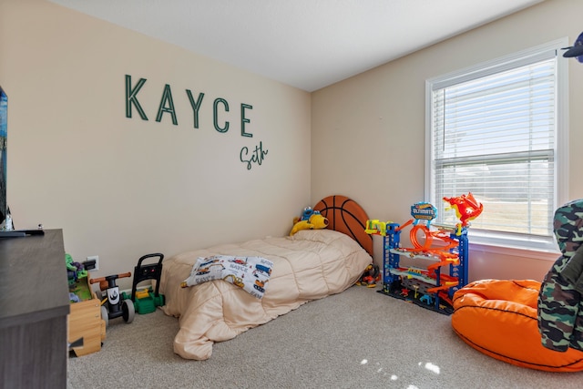 bedroom featuring multiple windows and carpet