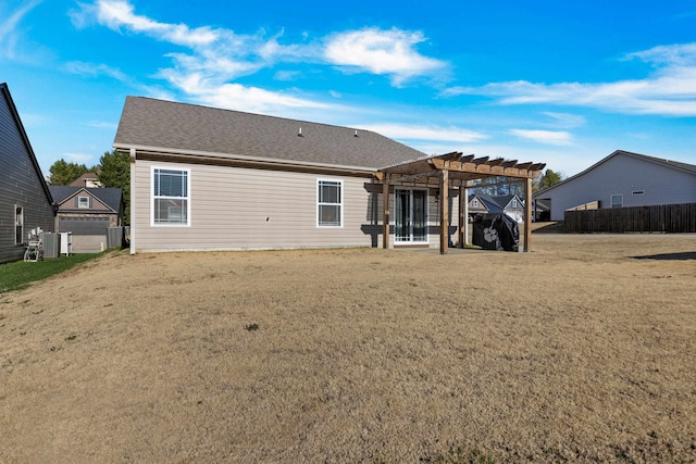 rear view of house with a pergola and a yard