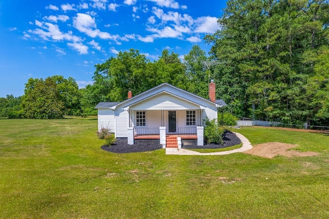 view of front of property with a porch and a front lawn