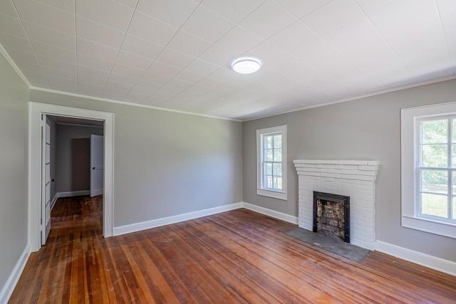 unfurnished living room with a fireplace, dark wood-type flooring, and ornamental molding