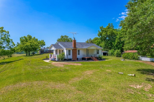 rear view of property with a yard