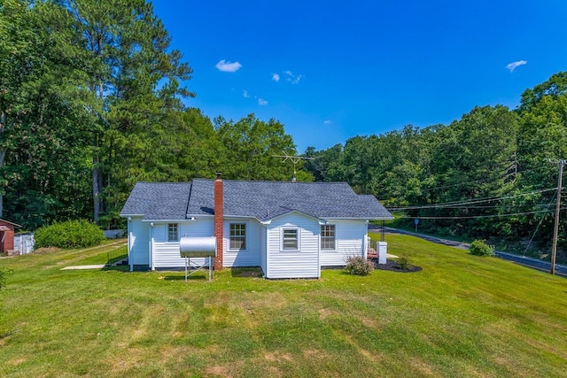 back of house with a yard