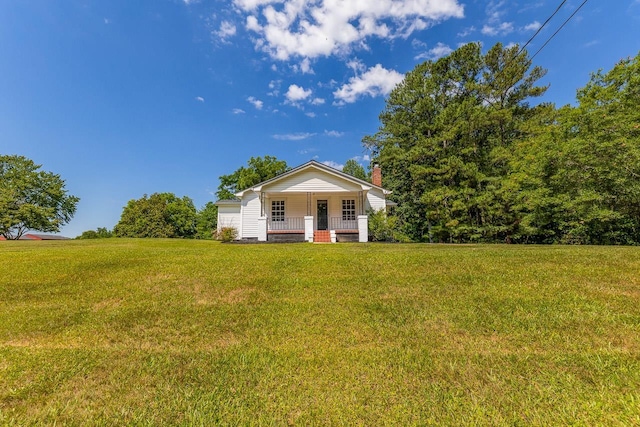 view of front of property featuring covered porch and a front yard