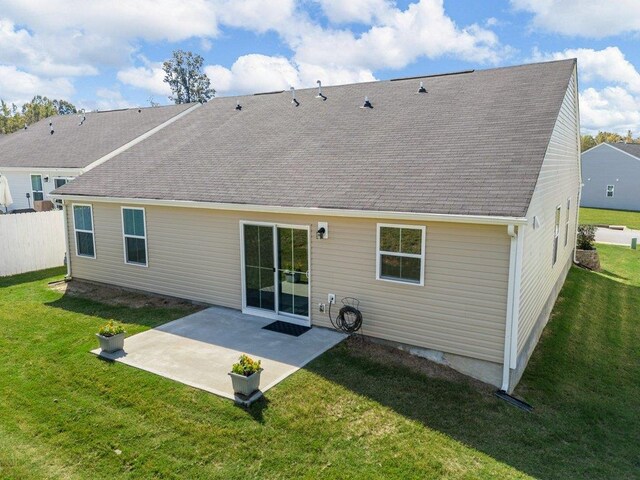 back of property featuring a yard and a patio