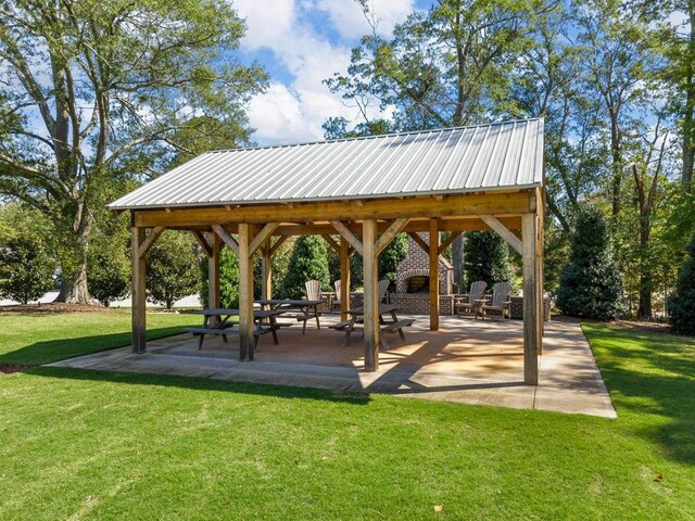 surrounding community featuring a gazebo, a patio, and a lawn