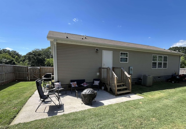 rear view of property featuring cooling unit, a yard, and a patio