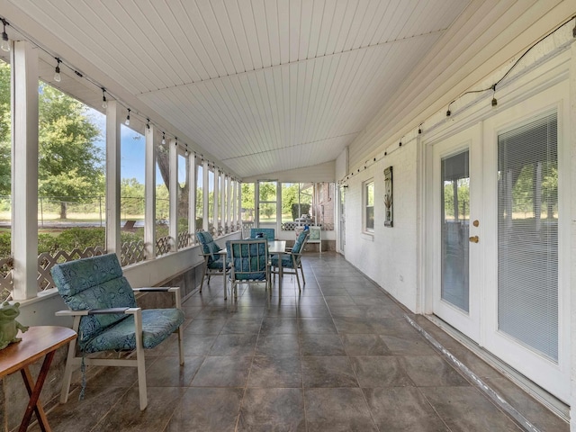 sunroom / solarium featuring lofted ceiling