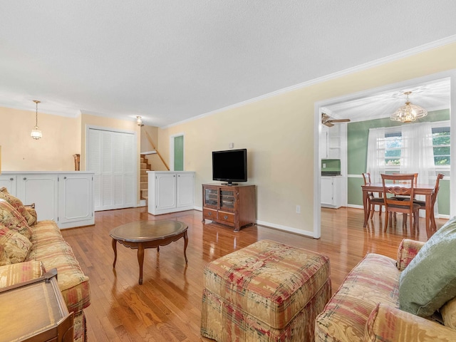 living room featuring light hardwood / wood-style floors and ornamental molding