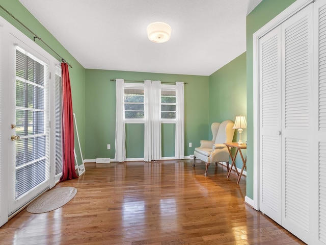 living area with hardwood / wood-style floors