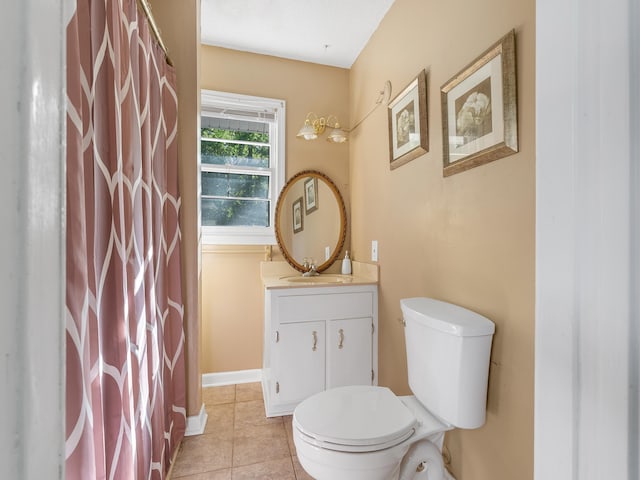 bathroom with tile patterned flooring, vanity, and toilet