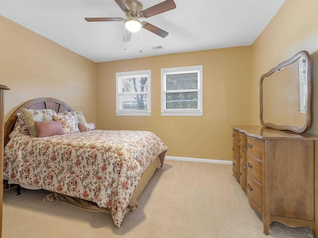 bedroom with light carpet and ceiling fan