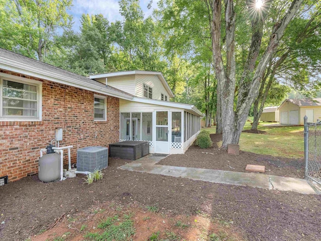 exterior space with a sunroom and cooling unit