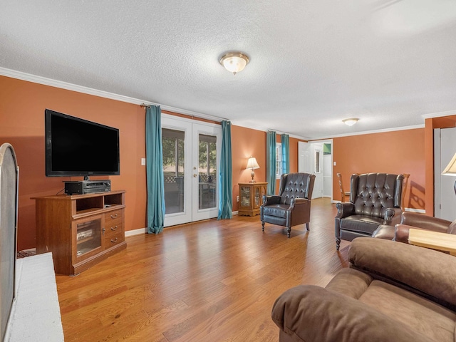 living room with crown molding, french doors, a textured ceiling, and hardwood / wood-style flooring