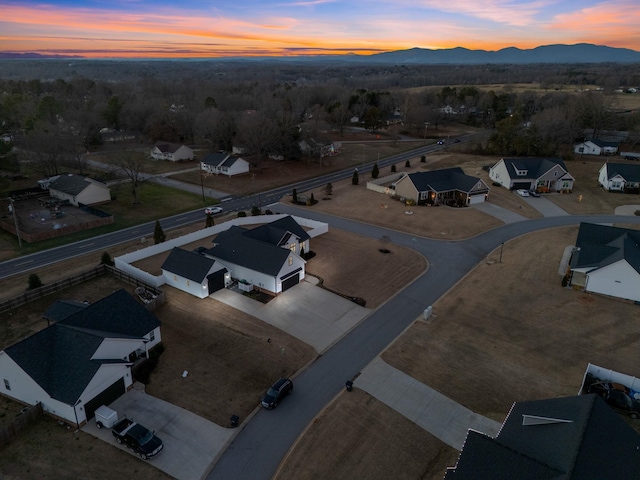 aerial view at dusk featuring a mountain view