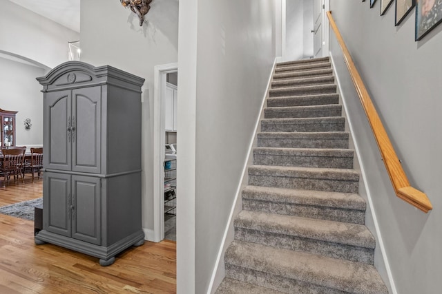 stairs featuring wood-type flooring