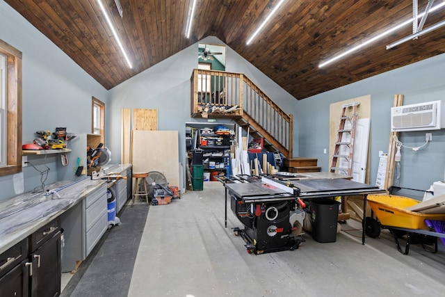 garage with a workshop area, an AC wall unit, ceiling fan, and wooden ceiling