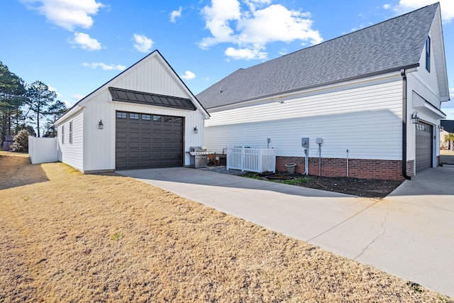 view of home's exterior with cooling unit, a garage, and an outdoor structure