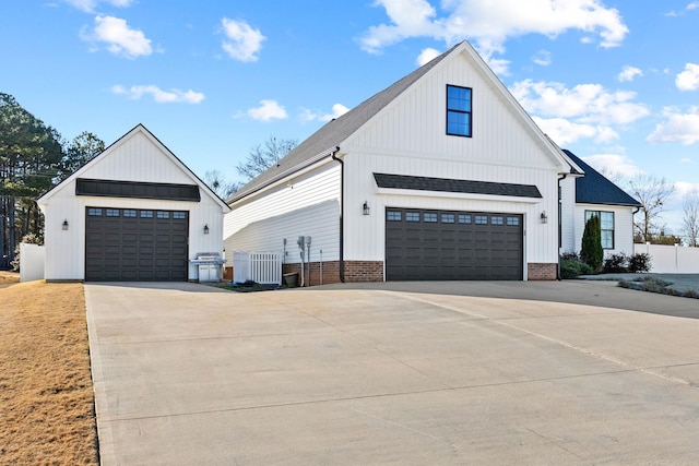 modern inspired farmhouse with a garage and central AC unit