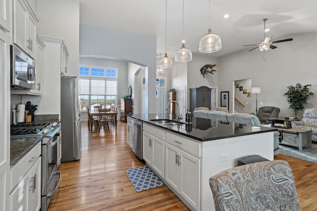 kitchen with white cabinetry, ceiling fan, sink, a center island with sink, and appliances with stainless steel finishes