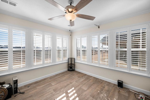 unfurnished sunroom featuring ceiling fan