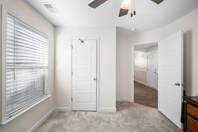 unfurnished bedroom featuring carpet flooring and ceiling fan