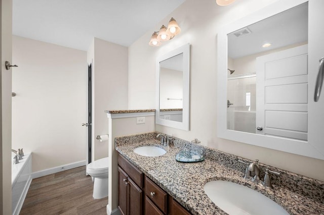 full bathroom featuring hardwood / wood-style floors, vanity, separate shower and tub, and toilet