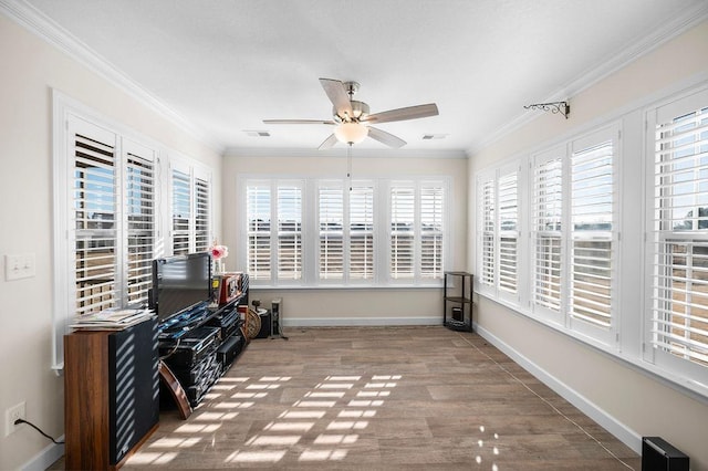 unfurnished room with a wealth of natural light, ceiling fan, hardwood / wood-style flooring, and ornamental molding