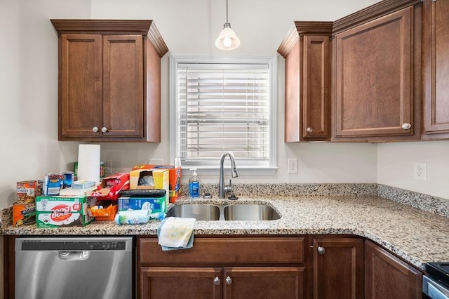 kitchen with light stone countertops, dishwasher, sink, range with electric stovetop, and pendant lighting