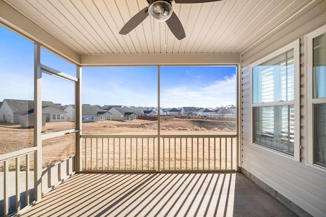 sunroom / solarium featuring ceiling fan