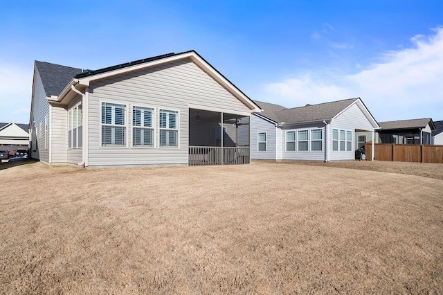 back of house with a sunroom and solar panels