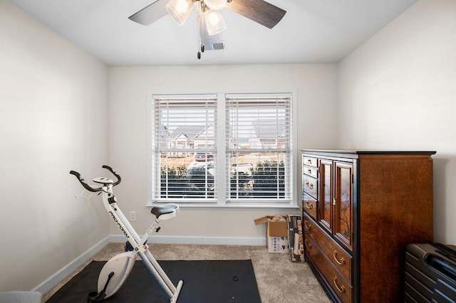 exercise room featuring light carpet and ceiling fan