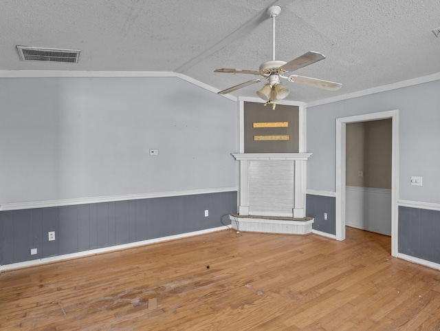 unfurnished living room with a textured ceiling, light hardwood / wood-style flooring, vaulted ceiling, and ceiling fan