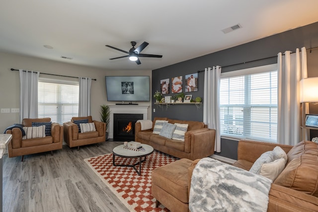 living room featuring light wood-type flooring and ceiling fan