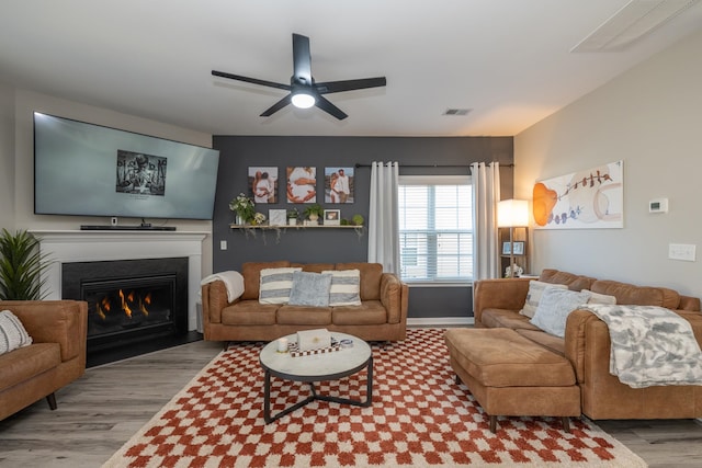 living room featuring ceiling fan and light wood-type flooring