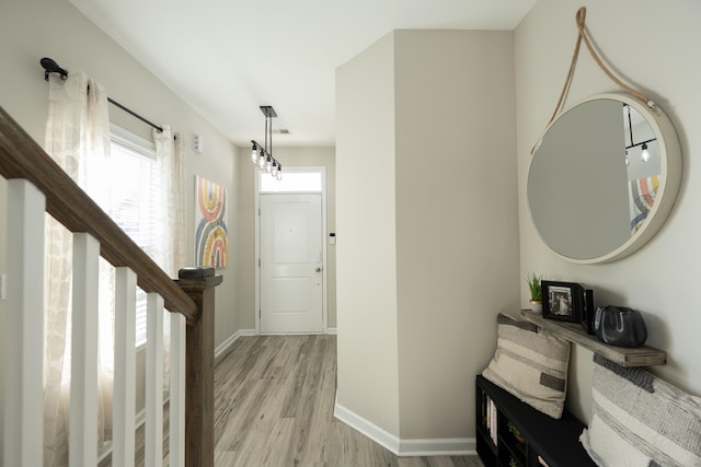 corridor with light hardwood / wood-style flooring