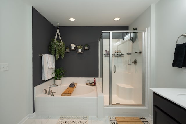 bathroom featuring tile patterned flooring, vanity, and shower with separate bathtub