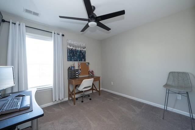 carpeted office space featuring ceiling fan