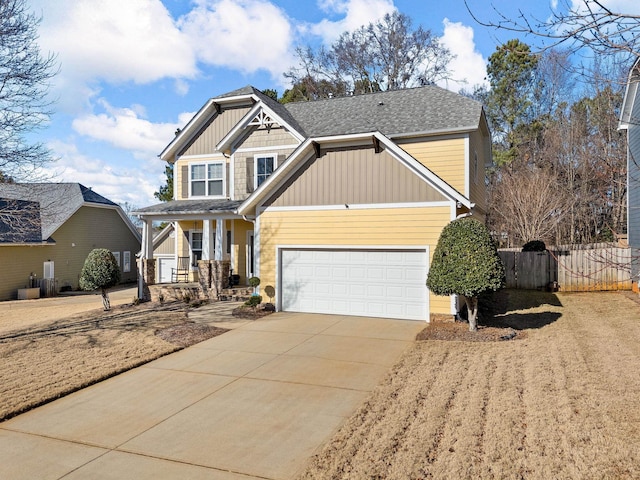 craftsman inspired home featuring covered porch and a garage