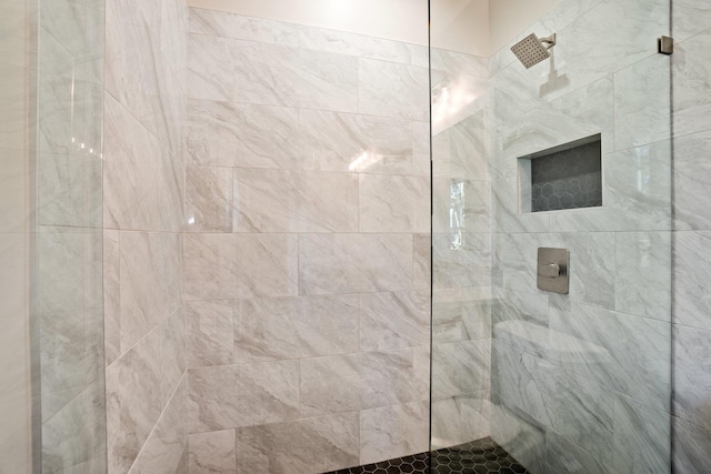 bathroom with a tile shower