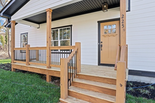 view of exterior entry with a porch