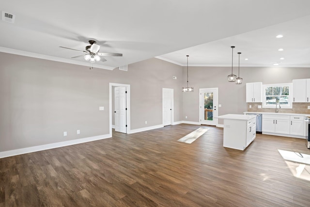 kitchen with stainless steel dishwasher, ceiling fan, white cabinets, a center island, and hanging light fixtures