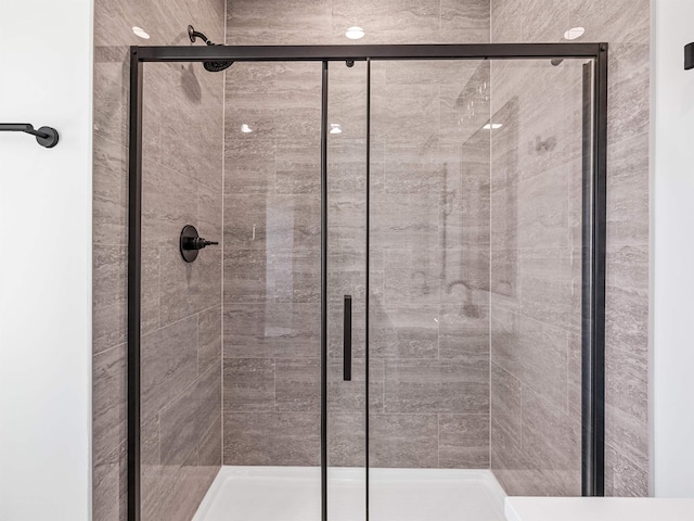 bathroom with a shower with shower door