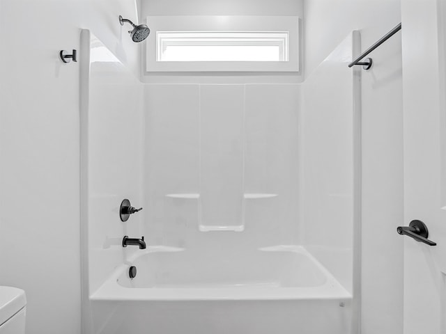 bathroom featuring toilet and bathing tub / shower combination