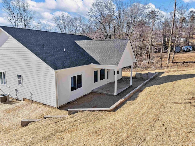 view of home's exterior featuring a lawn, central AC, and a patio