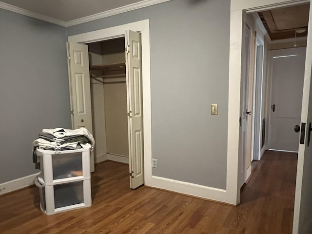 bedroom with dark hardwood / wood-style floors, a closet, and ornamental molding