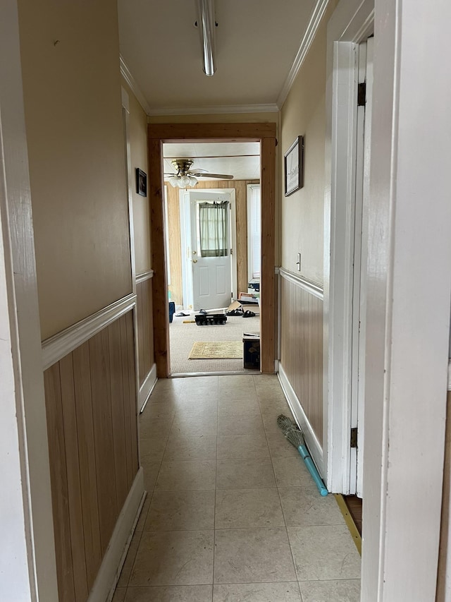 hallway featuring wooden walls and ornamental molding