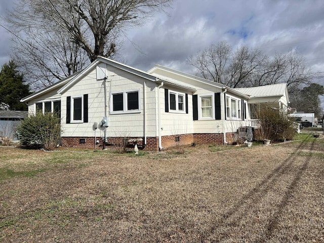 view of property exterior featuring a lawn